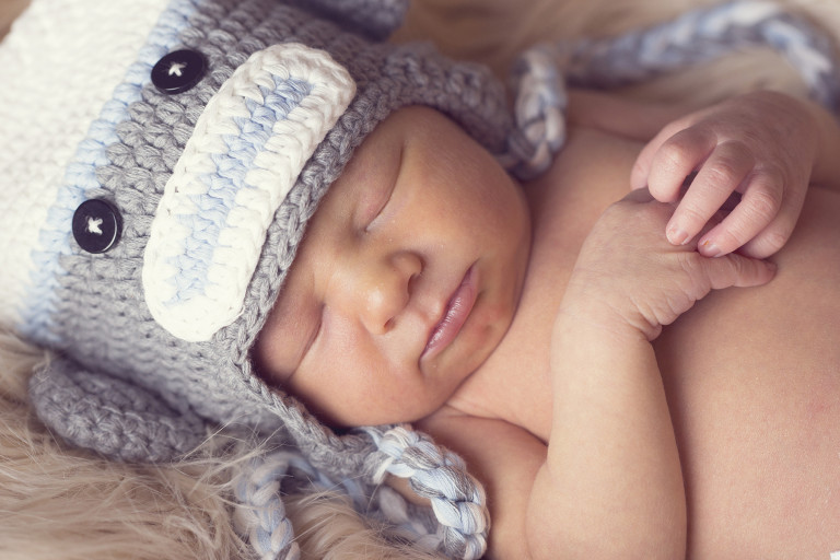 Newborn Pictures holding hands sleepiing