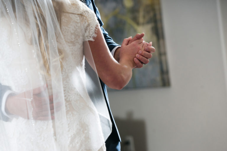 Bride and Groom hold hands during first dance