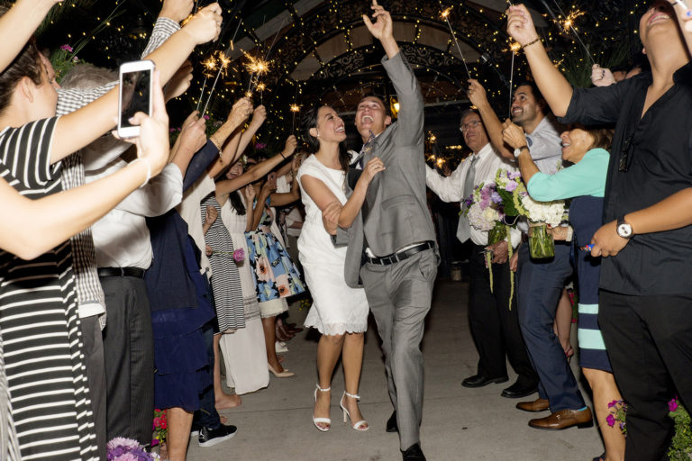 Excited Wedding Couple Exits to sparklers