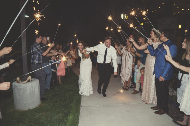 Bride and Groom Running through sparklers at wedding