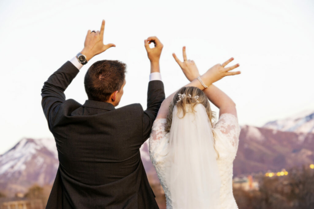 Bride and Groom making Love Sign with hands