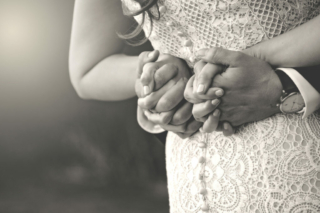 Bride and Groom Holding hands behind back